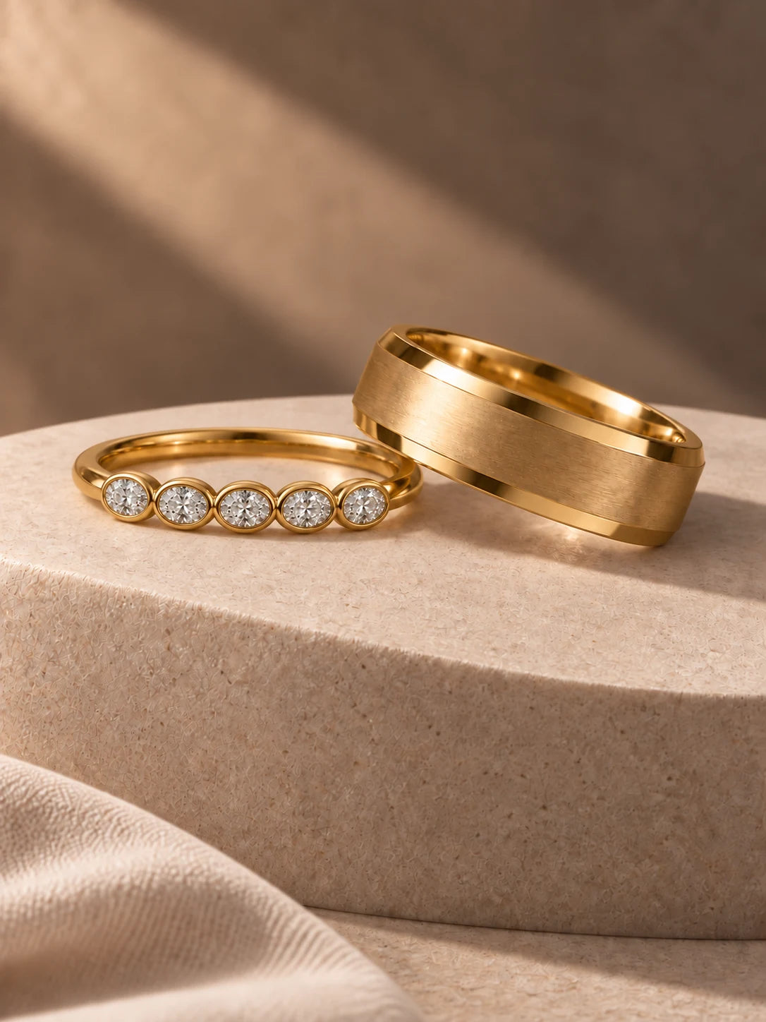 Gold wedding bands on sculptural ivory stone