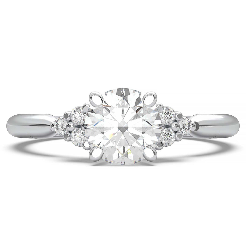 Round lab-grown diamond cluster engagement ring with a low-profile setting and accent diamonds.