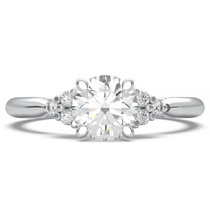 Round lab-grown diamond cluster engagement ring with a low-profile setting and accent diamonds.