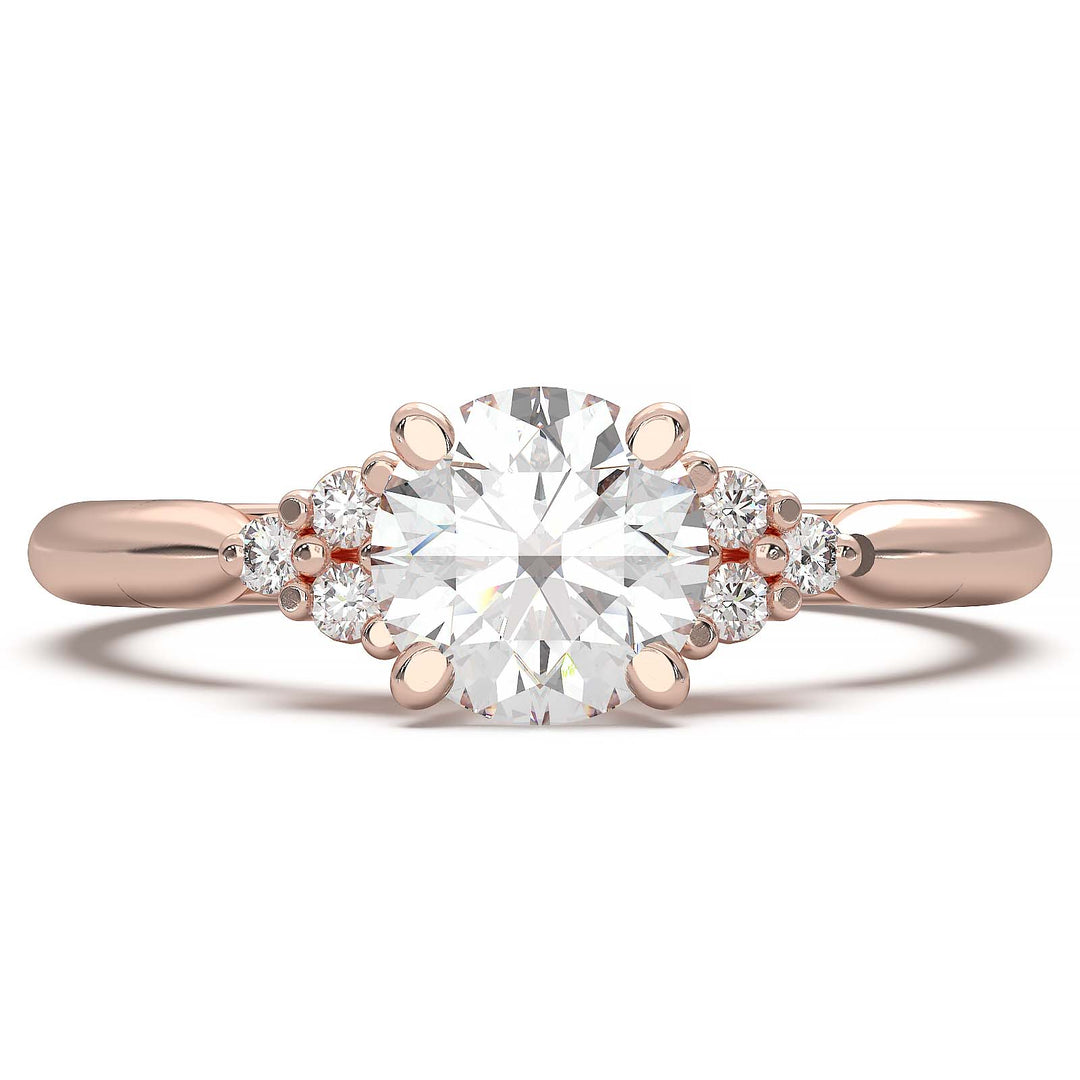 Round lab-grown diamond cluster engagement ring with a low-profile setting and accent diamonds.