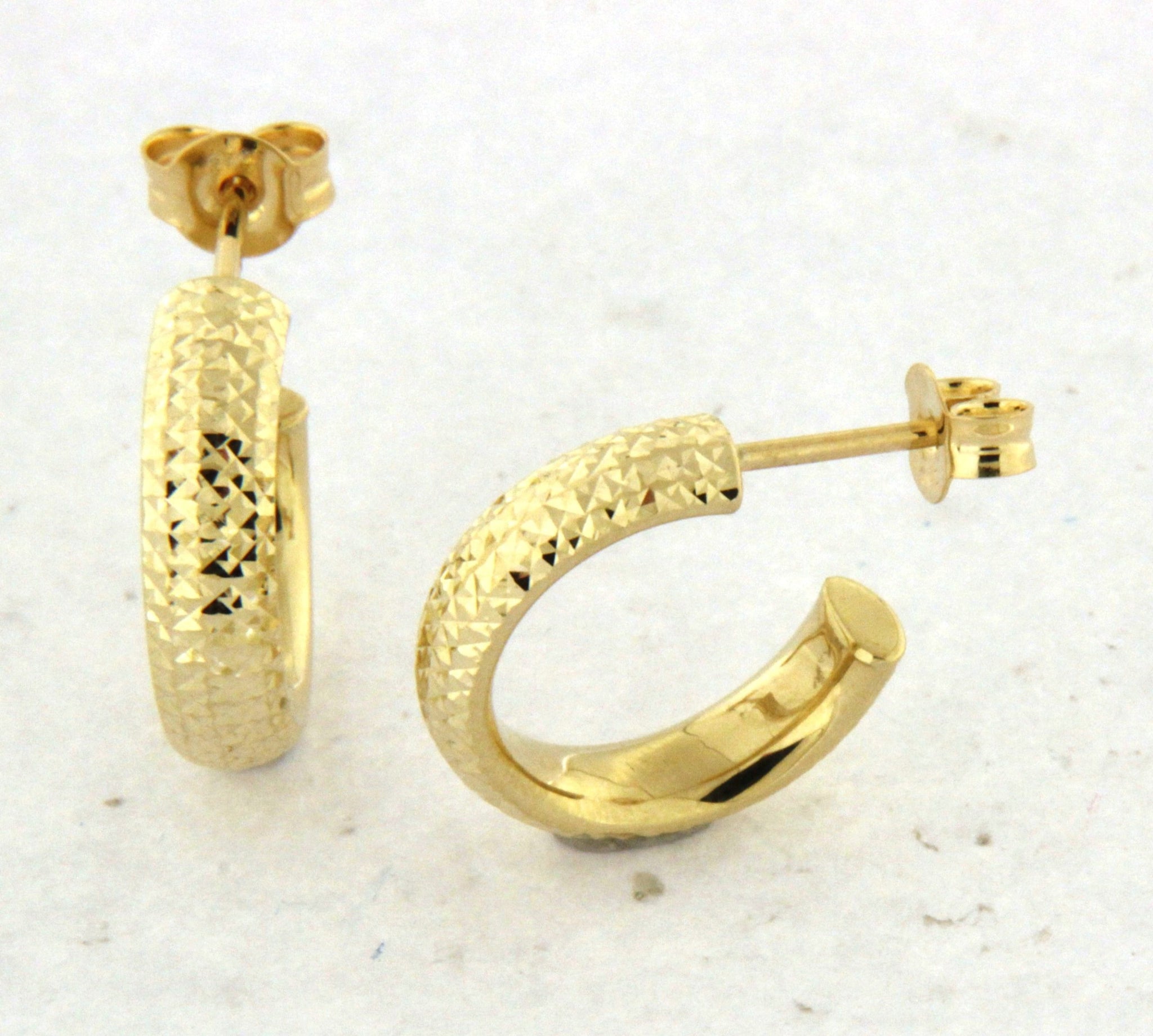 10k yellow gold textured hoop earrings with faceted design and stud-back closure.