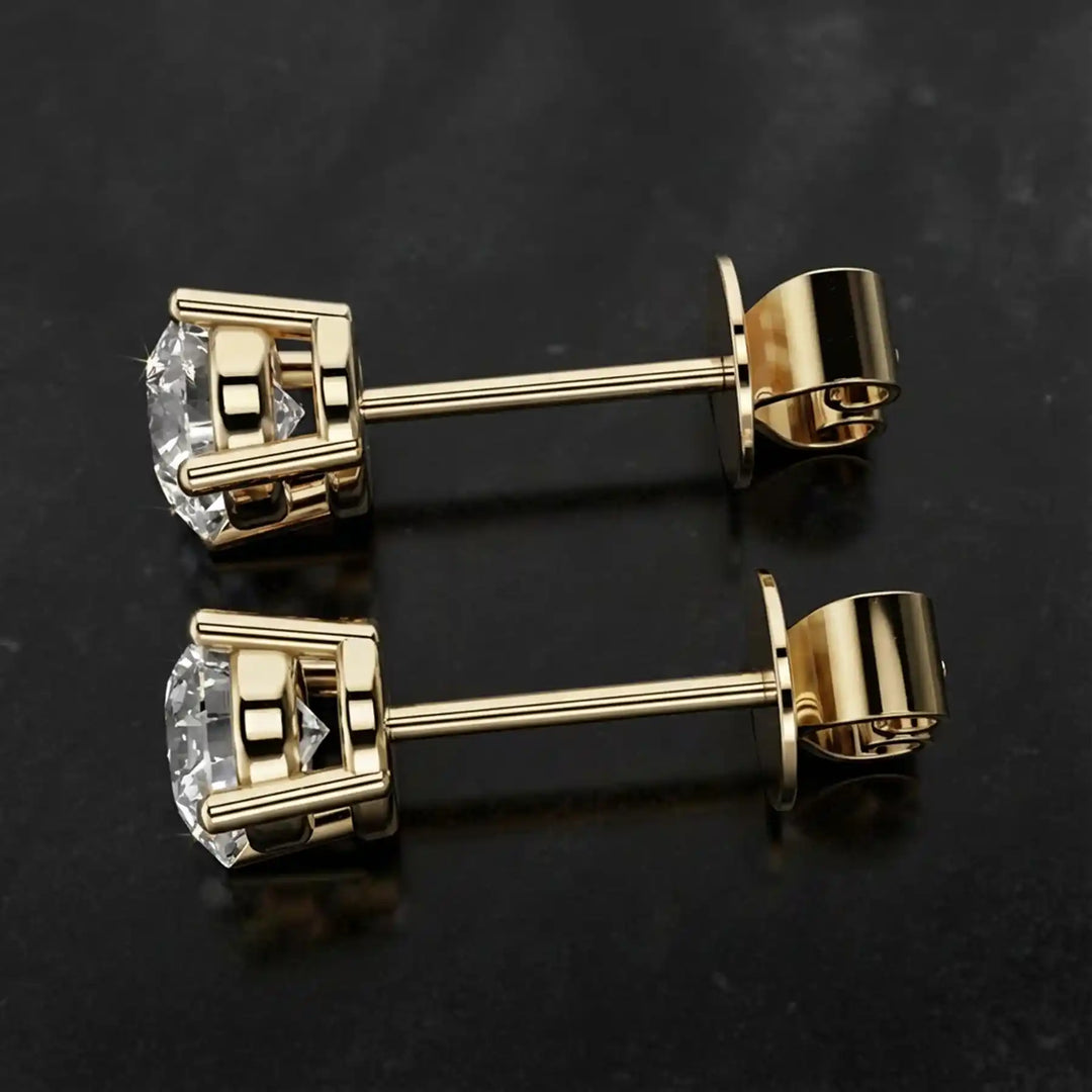 Round lab-grown diamond four-prong basket stud earrings displayed on black surface.