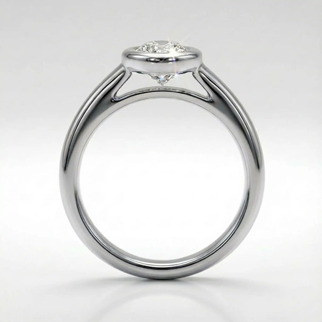 Marquise lab-grown diamond bezel engagement ring displayed on a soft surface.
