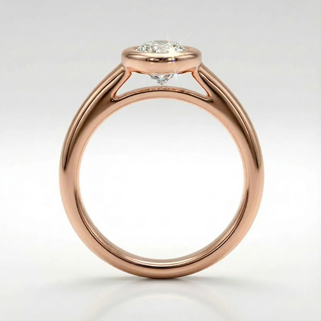 Marquise lab-grown diamond bezel engagement ring displayed on a soft surface.
