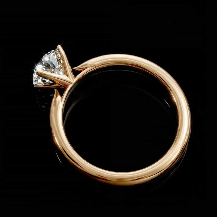 Round diamond cathedral solitaire engagement ring shown on reflective surface.
