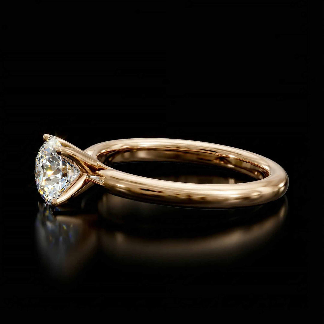 Round diamond cathedral solitaire engagement ring shown on reflective surface.
