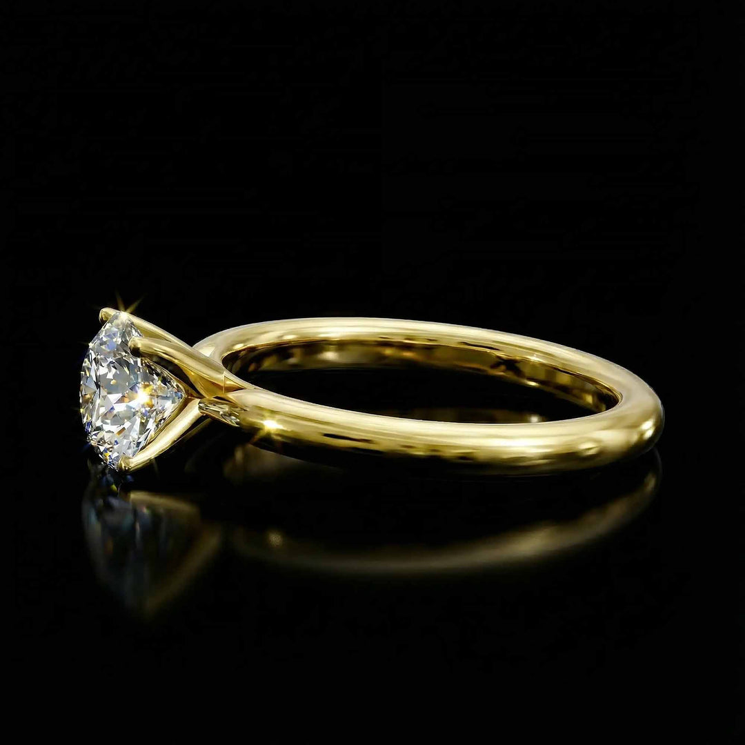 Round diamond cathedral solitaire engagement ring shown on reflective surface.
