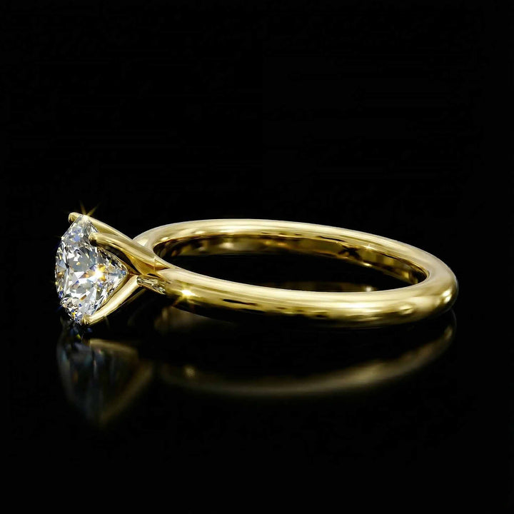 Round diamond cathedral solitaire engagement ring shown on reflective surface.
