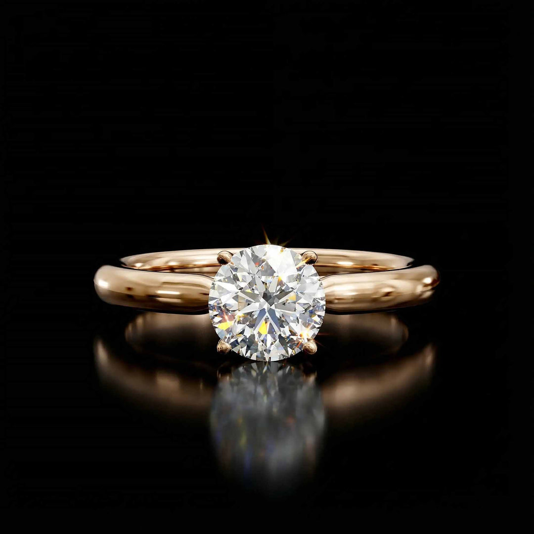 Round diamond cathedral solitaire engagement ring shown on reflective surface.
