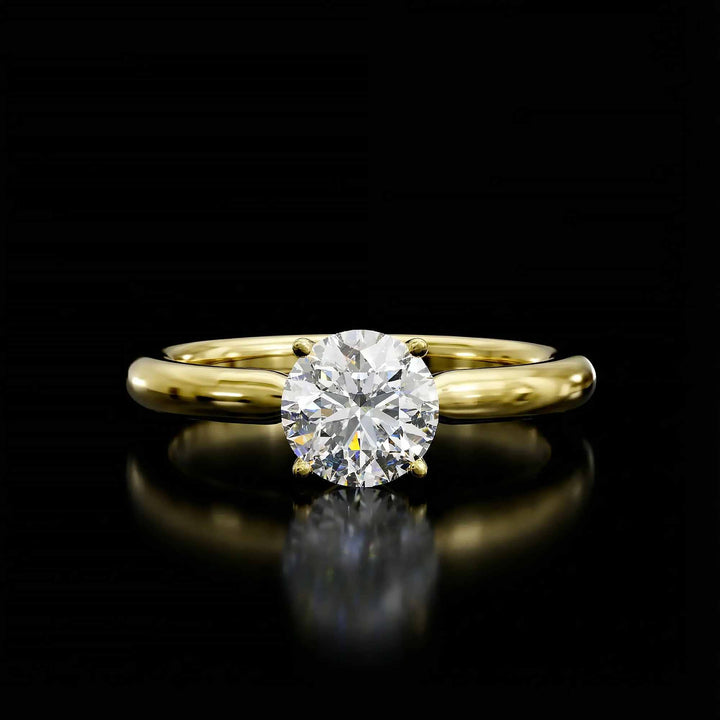 Round diamond cathedral solitaire engagement ring shown on reflective surface.
