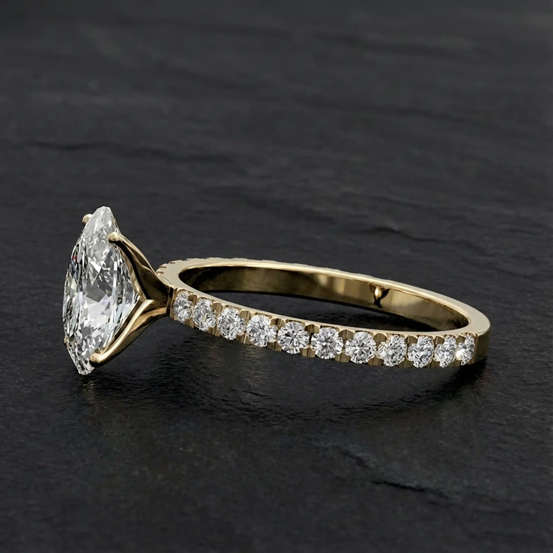 Oval lab diamond pavé engagement ring displayed on dark stone background.
