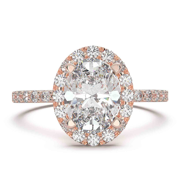 Oval diamond halo engagement ring with pavé diamond band and custom prong setting.