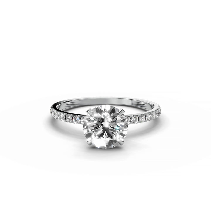 Round diamond pavé engagement ring in white gold.