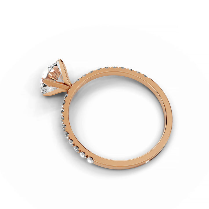 Round diamond Pavé engagement ring in rose gold.
