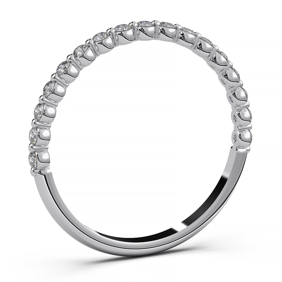 Floating lab-grown diamond wedding band with a shared prong setting and a single prong between each diamond.