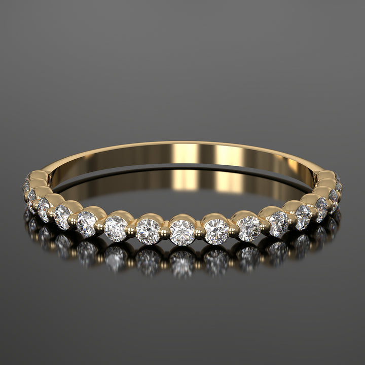 Dainty half eternity ring with floating diamonds in single prong shared setting.