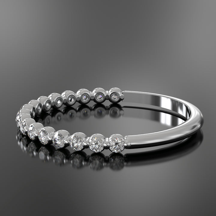 Dainty half eternity ring with floating diamonds in single prong shared setting.