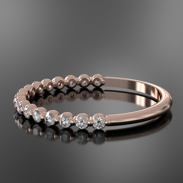 Dainty half eternity ring with floating diamonds in single prong shared setting.