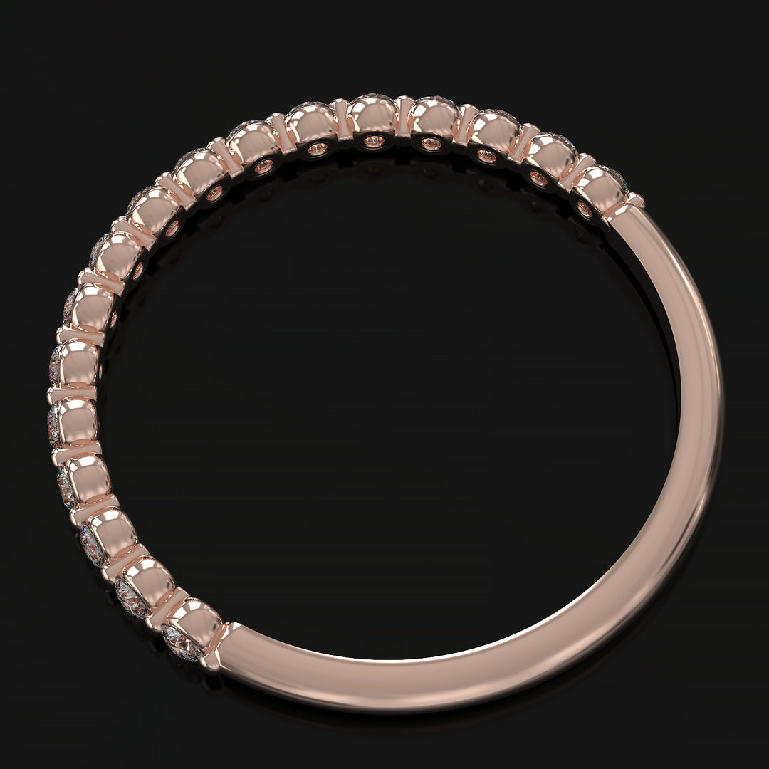 Dainty half eternity ring with floating diamonds in single prong shared setting.