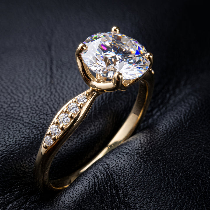 1.67CT round moissanite engagement ring with pave moissanite accents, set in 14K gold.