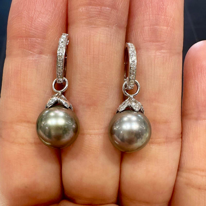 Light gray Tahitian pearl earrings with green overtone, 10.5mm round pearls set in 14K white gold with small diamonds.