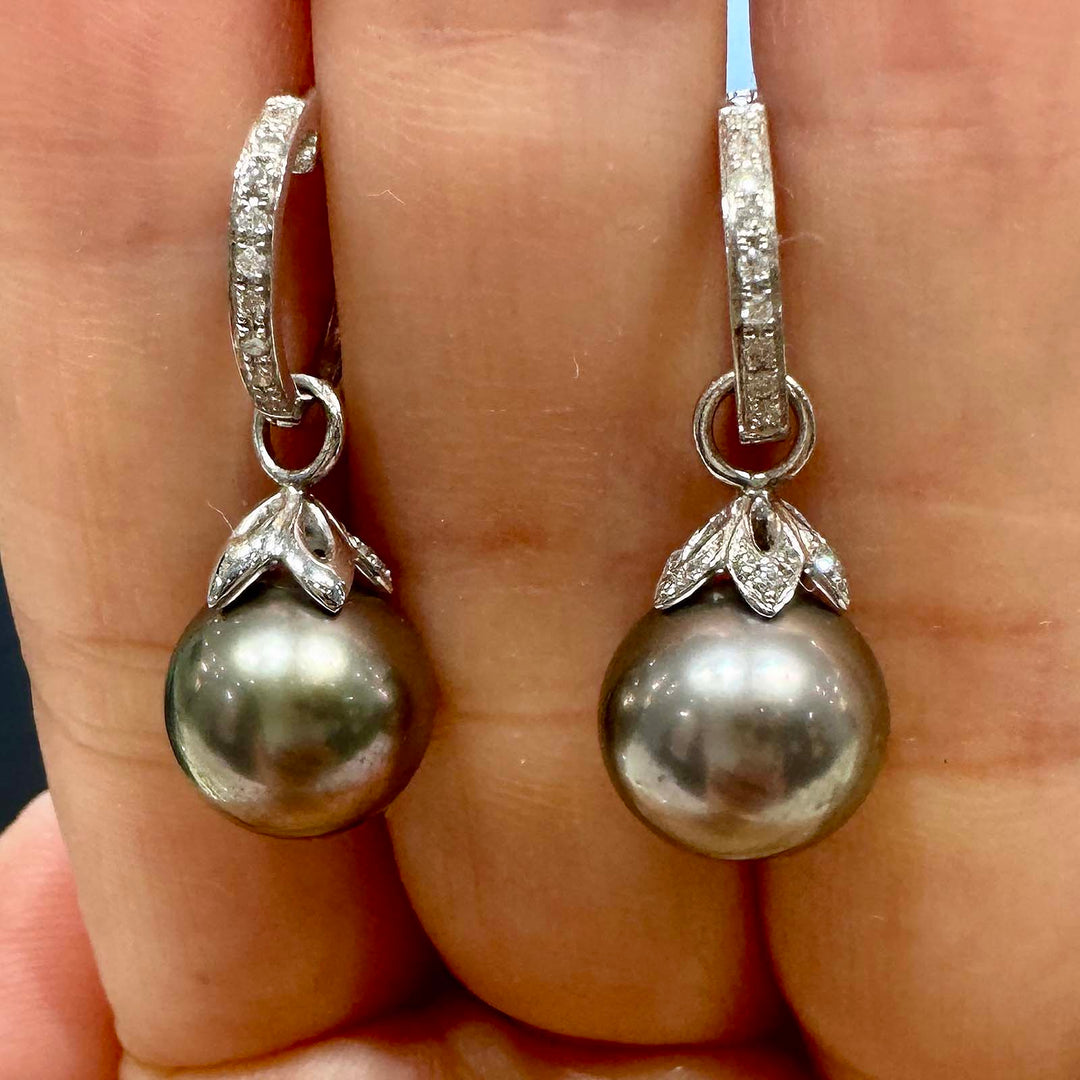 Light gray Tahitian pearl earrings with green overtone, 10.5mm round pearls set in 14K white gold with small diamonds.