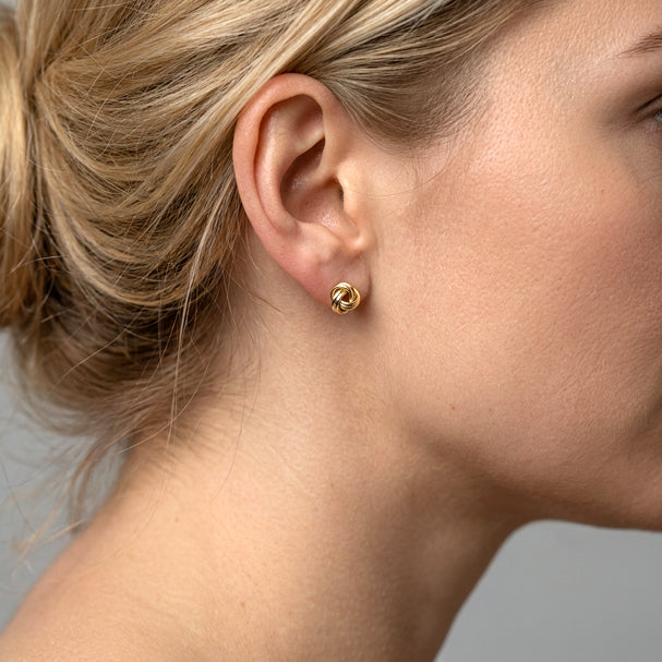 Yellow Gold Love Knot Stud Earrings - worn on ear