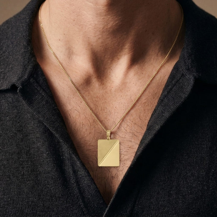 10K yellow gold rectangular tag pendant with diagonal satin and polished halves, 26.8 x 21 mm, 0.4 mm thick, worn by a man on a 22 inch chain