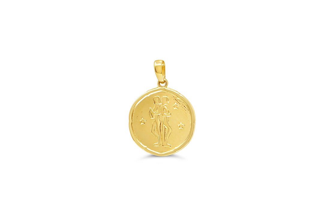 10K yellow gold Gemini zodiac pendant: a round medallion with the twins standing side by side raised in polished gold and small stars on a textured background