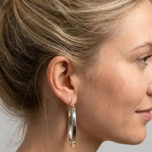 White Gold High Polish Flat Edge Oval Hoop Earrings, 17.2mm - worn on ear