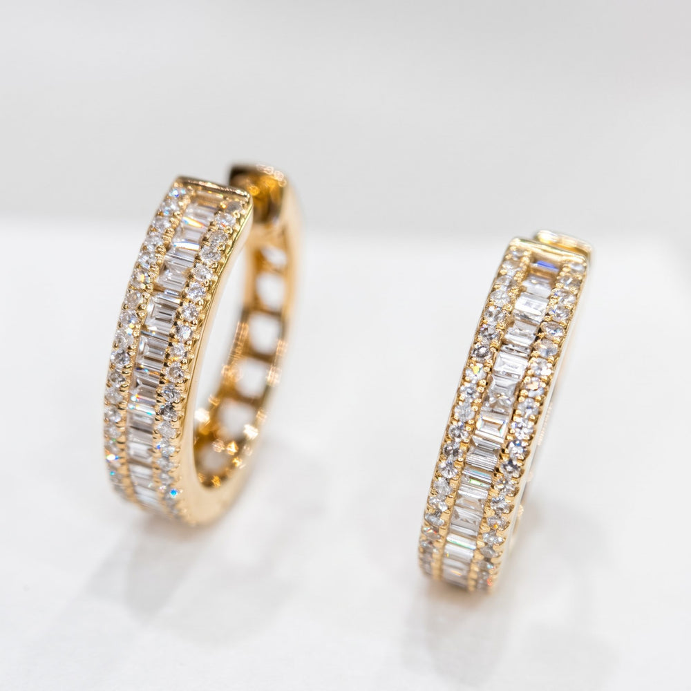 Side-by-side studio view of RUDIX 14k yellow gold triple-row baguette and round natural diamond huggie hoop earrings