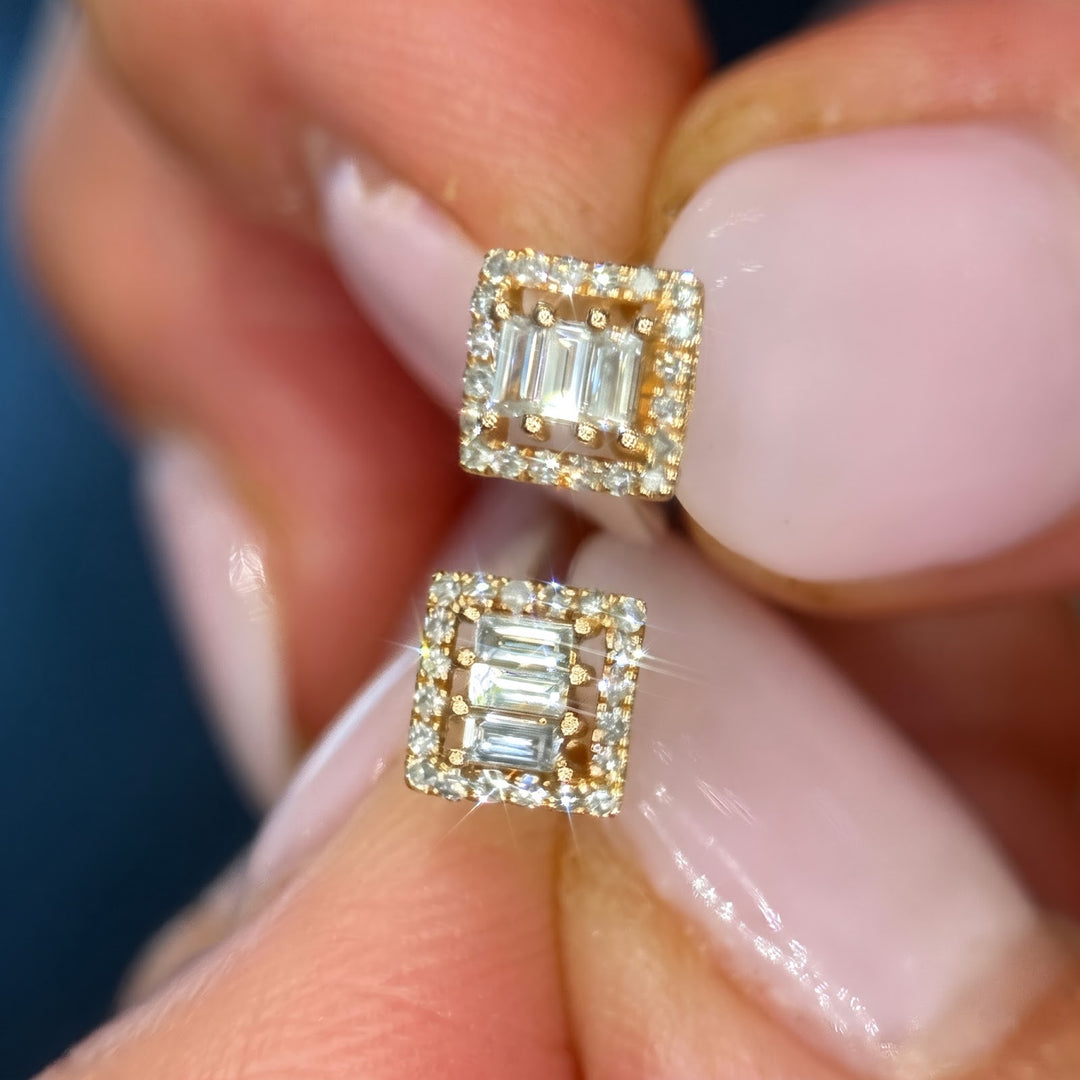 14k yellow gold natural diamond studs held in hand, fronts toward camera