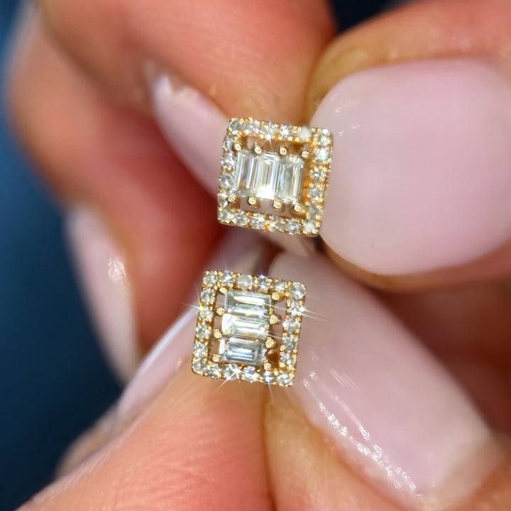 14k yellow gold natural diamond studs held in hand, fronts toward camera