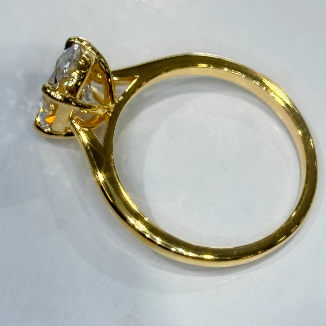 Close-up of the 1.92 ct oval lab-grown diamond held in a four-claw setting in 14k yellow gold