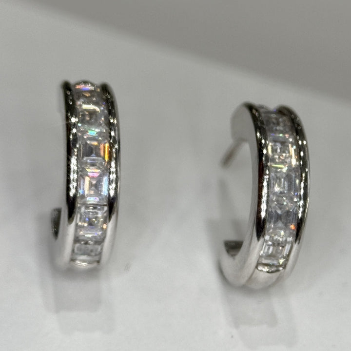 14k white gold moissanite three-quarter hoops, one face-on and one turned