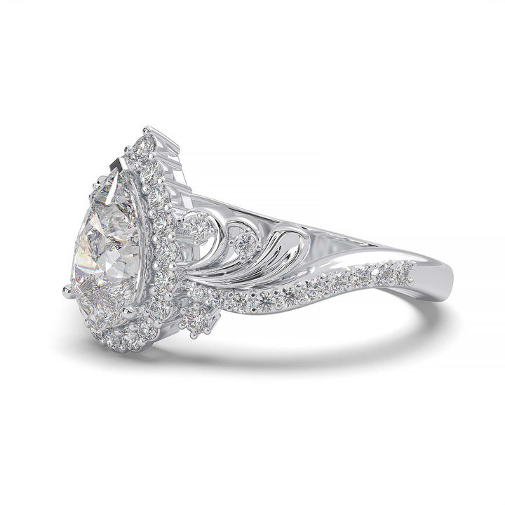 Pear-shaped diamond vintage engagement ring with custom prongs and halo design.