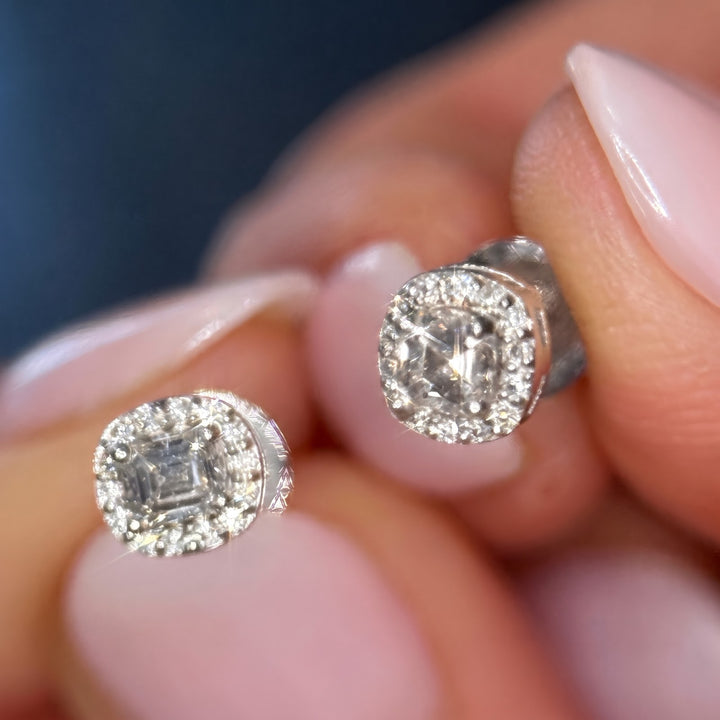 10k white gold lab diamond halo studs held in hand, fronts toward camera