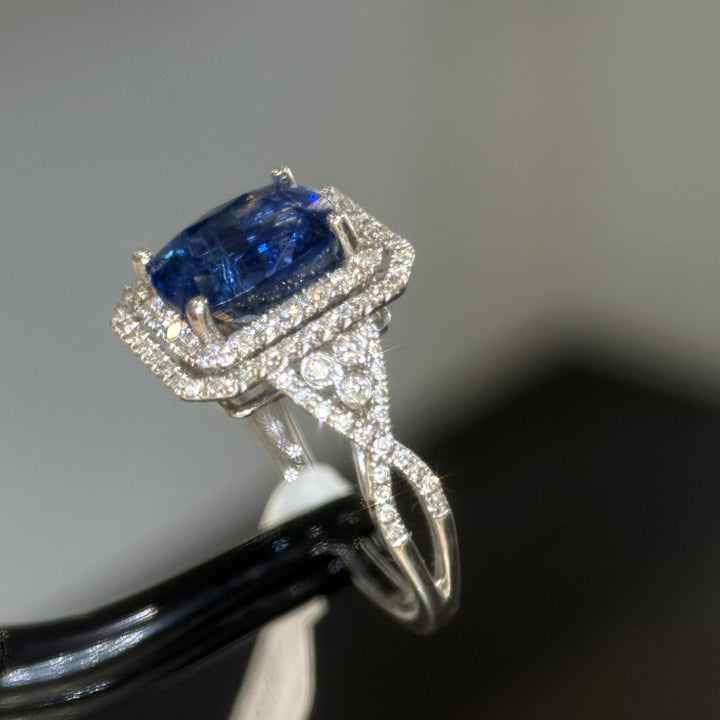 Blue sapphire double halo ring in 14K white gold, side view showing the twisted split shank