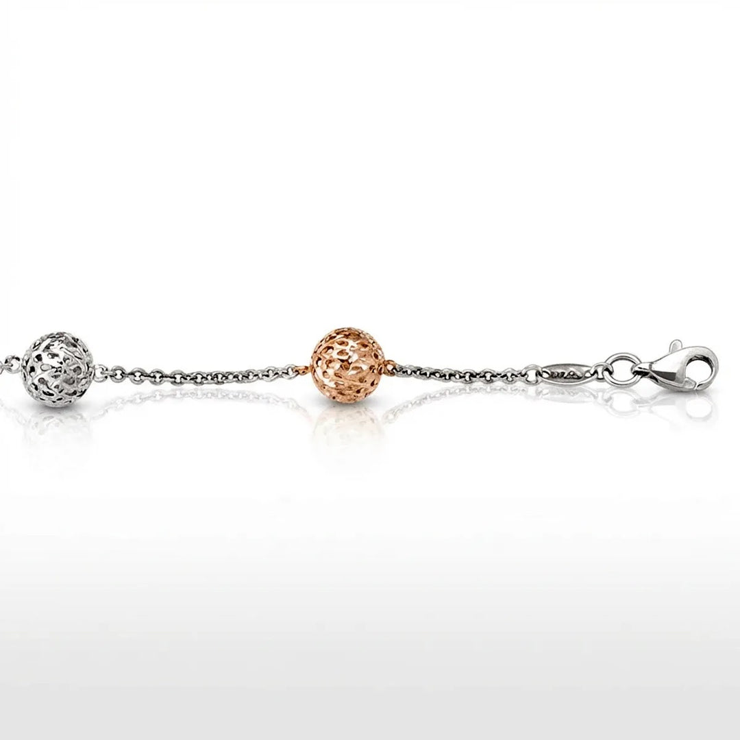 Two-tone white and rose gold fancy ball link bracelet with intricate openwork design