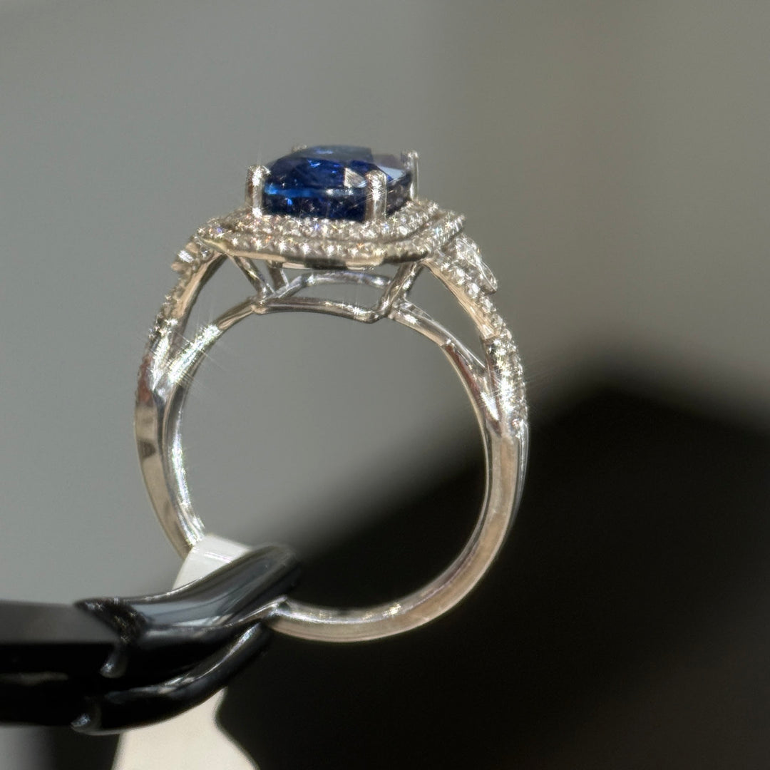 Blue sapphire halo engagement ring, open gallery and cathedral shoulders in 14K white gold