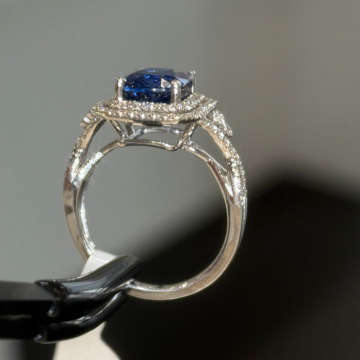 Blue sapphire halo engagement ring, open gallery and cathedral shoulders in 14K white gold