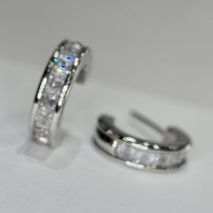 Close view of the moissanite channel on a 14k white gold three-quarter hoop
