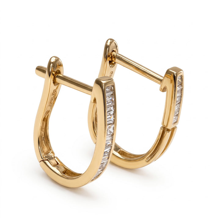 14k yellow gold natural diamond baguette huggies, three-quarter view with latch-back posts