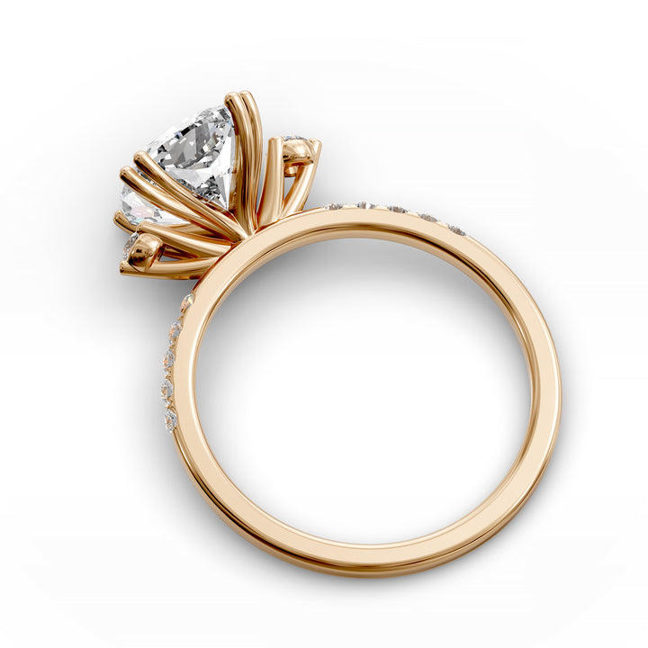 Cushion diamond three-stone engagement ring with pavé band shown in studio lighting.