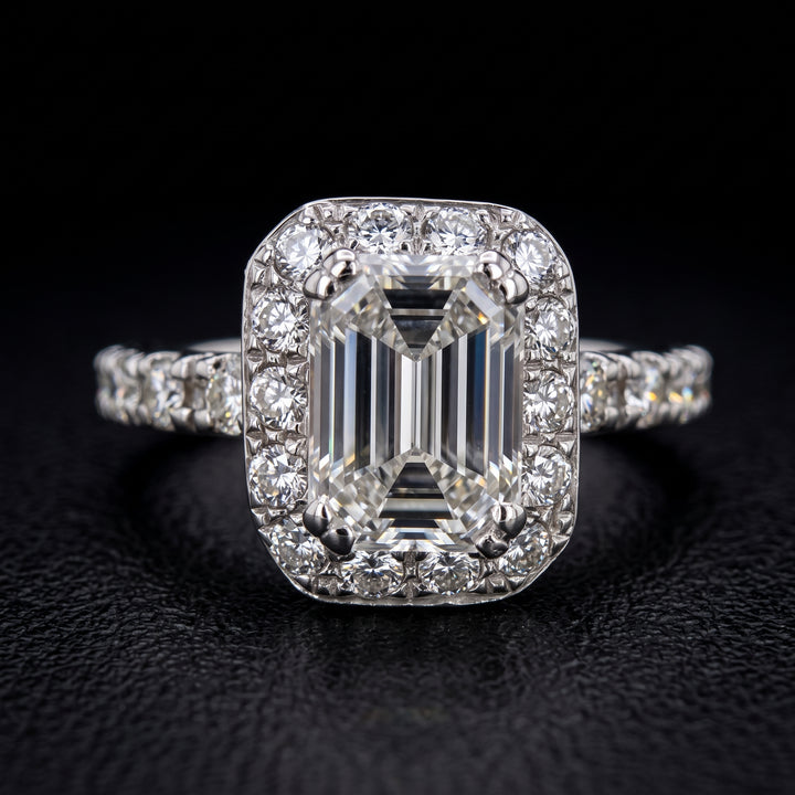 1.03 CT emerald-cut diamond halo engagement ring in 14K white gold with natural diamond accents.
