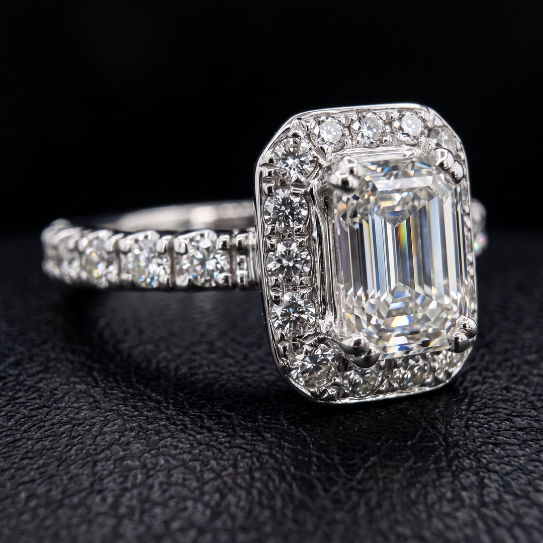1.03 CT emerald-cut diamond halo engagement ring in 14K white gold with natural diamond accents.