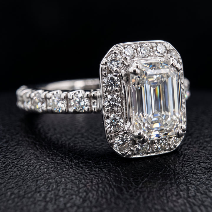 1.03 CT emerald-cut diamond halo engagement ring in 14K white gold with natural diamond accents.