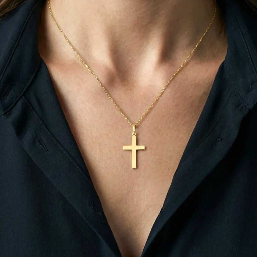 Minimal Latin Yellow Gold Cross Pendant worn on womens chest