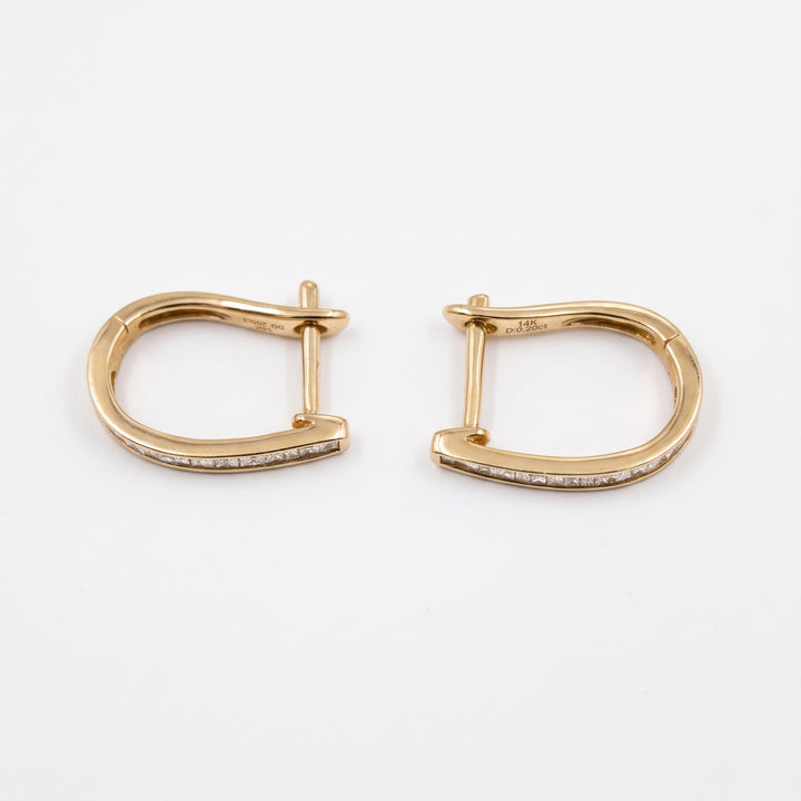 Back view of the 14k yellow gold baguette huggies, polished gold and posts