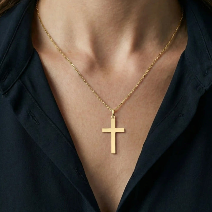 Minimal Latin Yellow Gold Cross Pendant worn on womens chest